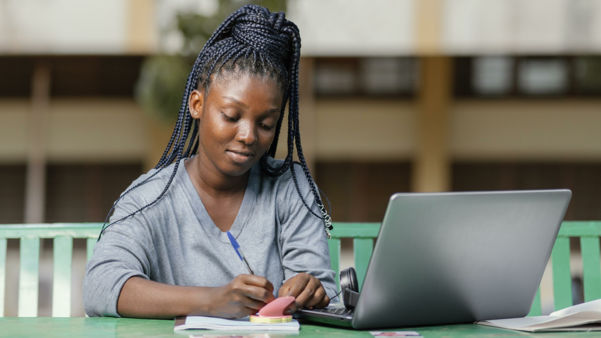 medium shot student studying with laptop